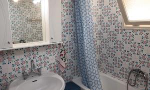 a bathroom with a sink and a shower at Sea view apartment in Plomari +20 photos