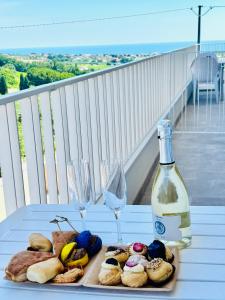 a table with a plate of food and a bottle of wine at Linea d Orizzonte in Francavilla al Mare