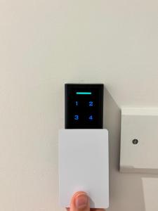 a person is holding up a lightswitch on a wall at Linea d Orizzonte in Francavilla al Mare