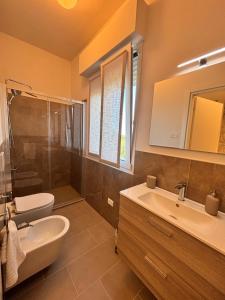 a bathroom with a sink and a toilet and a mirror at Linea d Orizzonte in Francavilla al Mare +19 photos