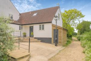 a white house with a porch and stairs at 1 Bed in Taunton oc-75135 in Isle Brewers