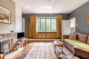 a living room with a couch and a fireplace at 2 Bed in Minehead oc-77363 in Withypool