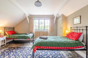 a bedroom with two beds and a window at 2 Bed in Minehead oc-77363 in Withypool