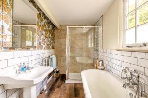 a bathroom with two sinks and a tub and a shower at 2 Bed in Minehead oc-77363 in Withypool +21 photos