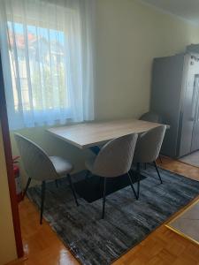 a table and two chairs in a room at Apartman Mimi in Bratunac +8 photos