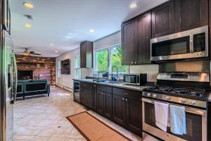 a kitchen with wooden cabinets and a stove top oven at Arlington Suite in Arlington