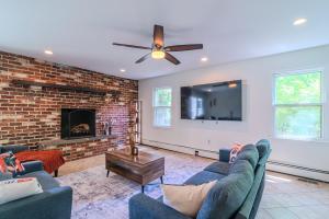 a living room with couches and a brick fireplace at Arlington Suite in Arlington