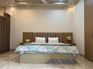 a bedroom with a large bed in a room at Kaizen Living in Guwahati +34 photos
