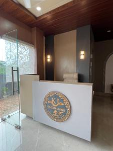 a sign on a reception desk in a room at Kaizen Living in Guwahati