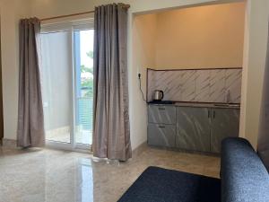 a living room with a large sliding glass door at Kaizen Living in Guwahati