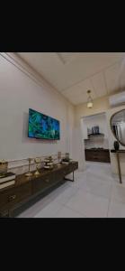a living room with a tv on the wall at Global properties in Faisalabad