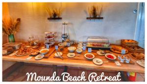 a table with many different types of food on it at Mounda Beach Retreat in Skala