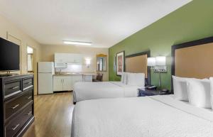 a hotel room with two beds and a kitchen at Extended Stay America Suites - Portland - Tigard in Tigard