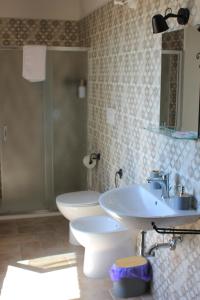 a bathroom with a sink and a toilet at B&B del Borgo in Ortezzano