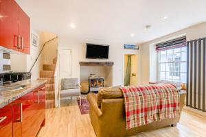 a kitchen and living room with a couch and a tv at 2 Bed in Cromer oc-2309 in Cromer +9 photos