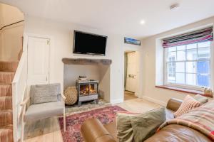 a living room with a fireplace and a tv at 2 Bed in Cromer oc-2309 in Cromer