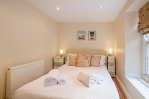 a bedroom with a bed with towels on it at 2 Bed in Cromer oc-2309 in Cromer
