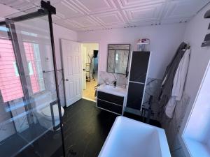 a bathroom with a toilet and a sink and a mirror at Appartement 2 - Est in Rimouski