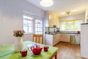 a kitchen with a table with red cups on it at 4 Bed in Ilkley oc-ds168 in Ilkley +13 photos