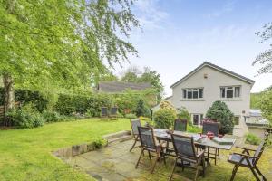 a patio with a table and chairs in a yard at 4 Bed in Ilkley oc-ds168 in Ilkley