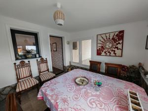 a bedroom with a bed with a table and two chairs at Apartman Leo in Mariánské Lázně