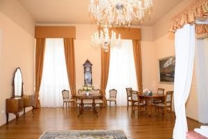a dining room with a table and a chandelier at Althanský palác in Znojmo