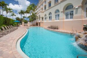 a swimming pool in front of a building at Hilton Naples in Naples