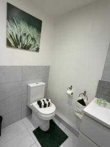 a bathroom with a white toilet and a sink at Stylish Charming London Flat Ruislip -Free Parking in Ruislip