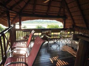 a group of chairs and tables on a deck at Bona Ngwenya Lodge & Safaris in Marloth Park +77 photos