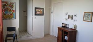 a room with a hallway with a chair and a mirror at La Maison d'Osquich in Musculdy