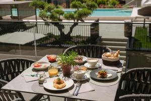a table with plates of food on it on a balcony at Amaris Suites Rabland, Südtirol in Rablà
