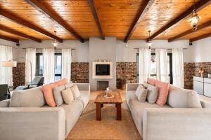 a living room with two couches and a table at Galeb Bed and Breakfast in Baćina