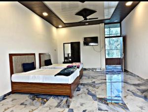 a bedroom with a large bed with a marble floor at SK Palace in Rāe Bareli