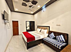 a bedroom with a bed and a couch at SK Palace in Rāe Bareli +16 photos
