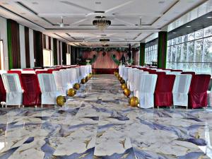a row of white chairs in a large room at SK Palace in Rāe Bareli