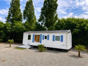 a white tiny house sitting in a gravel lot at Horizon Marin Escapade bord de mer à Cancale in Cancale