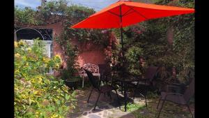 a table and chairs under an umbrella in a garden at Number eight in Beaumaris