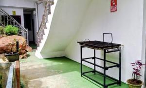a black table in a room with green floors and stairs at Breeze Mahagedara in Nuwara Eliya +15 photos