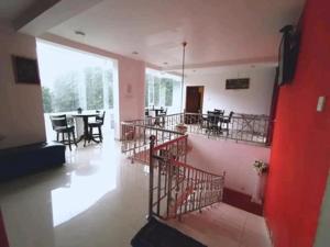 an empty room with a table and chairs in it at Breeze Mahagedara in Nuwara Eliya
