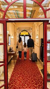 a group of people walking down a red carpet at Hotel Viki in Vienna
