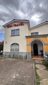 a saw travel building with a sign on it at Hostal Sam in Managua