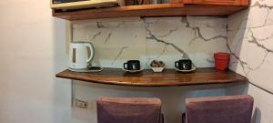 a wooden shelf with two coffee cups on it at CHE LOLITA HOUSE 2 in Buenos Aires