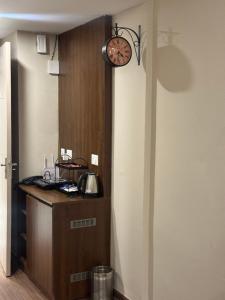 a clock on a wall next to a counter at CasaVerve stay in Greater Noida