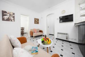 a living room with a couch and a table at Villa Emilio in Cala en Porter