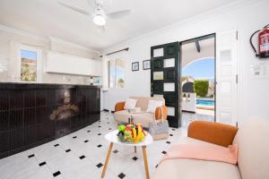 a living room with a tv and a table at Villa Emilio in Cala en Porter