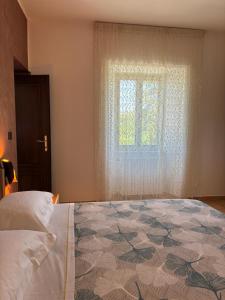 a bedroom with a bed and a window at Casa Ciccone-L'Aquila in Tornimparte +13 photos