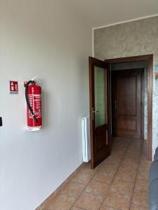a fire hydrant on the wall next to a door at Casa Ciccone-L'Aquila in Tornimparte