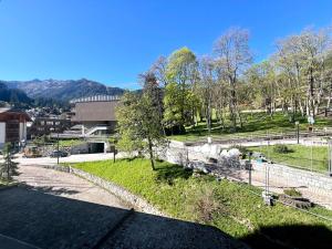 a train sitting on the tracks in a park at Monolocale Des Alpes 204 in Madonna di Campiglio