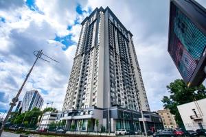 a tall white building on a city street at Вікторі Апарт in Kyiv