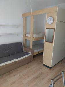 a room with a bunk bed and a clock at LaSpiaggia21 in Marotta